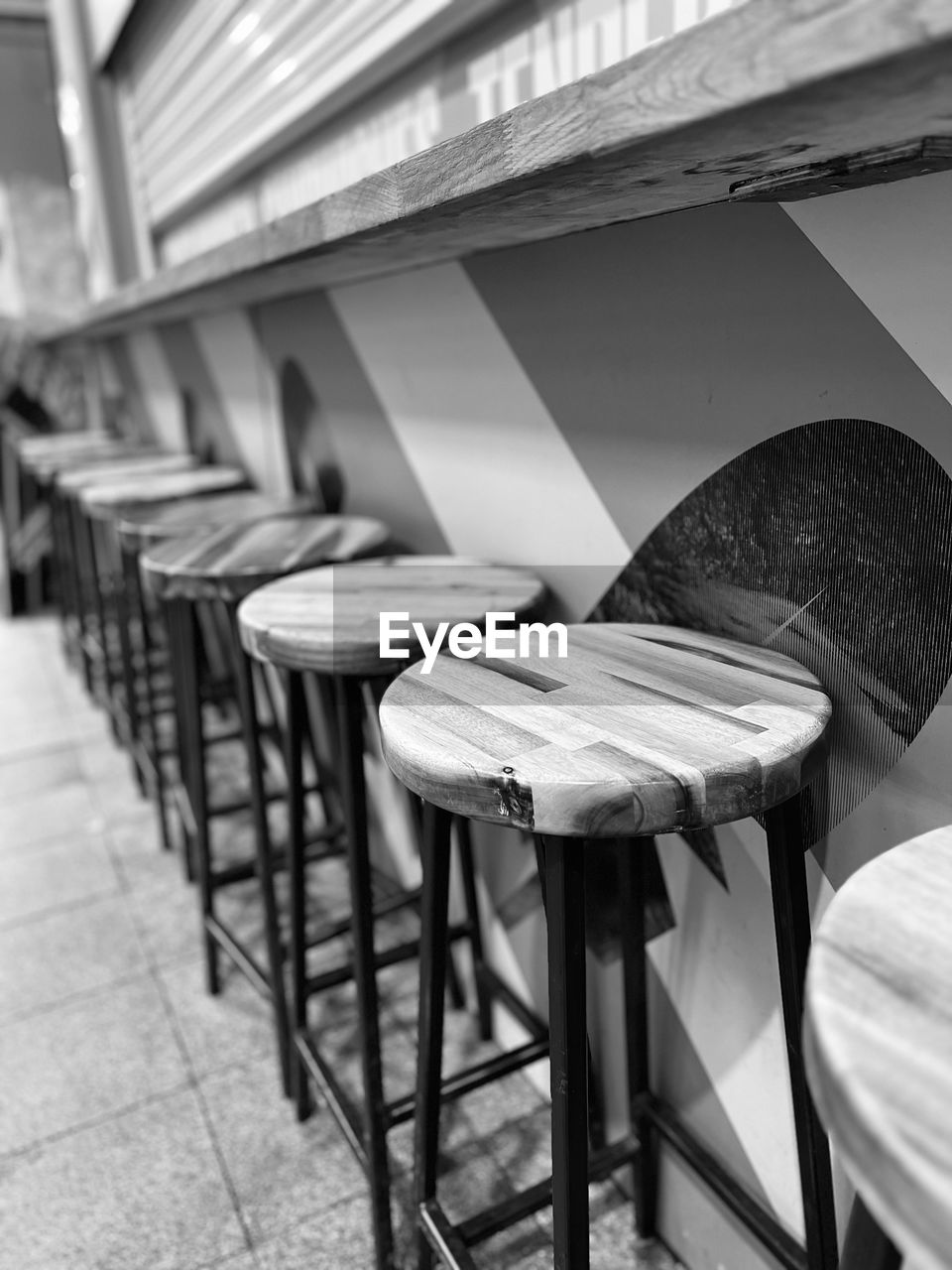 seat, chair, white, furniture, black, black and white, table, architecture, stool, monochrome, no people, monochrome photography, absence, built structure, indoors, in a row, interior design, empty, room, building, iron, cafe, flooring, restaurant