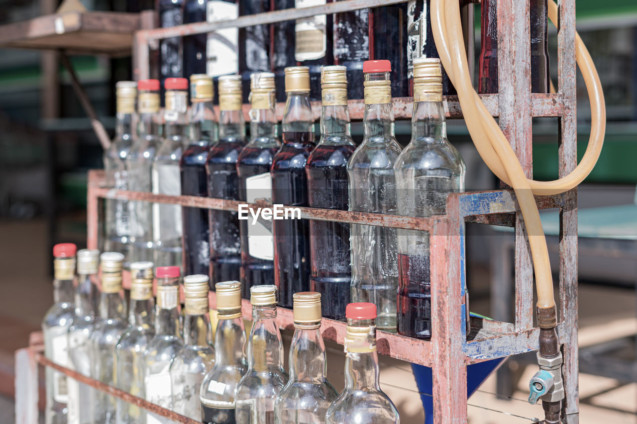 WINE BOTTLES ON SHELF AT BAR