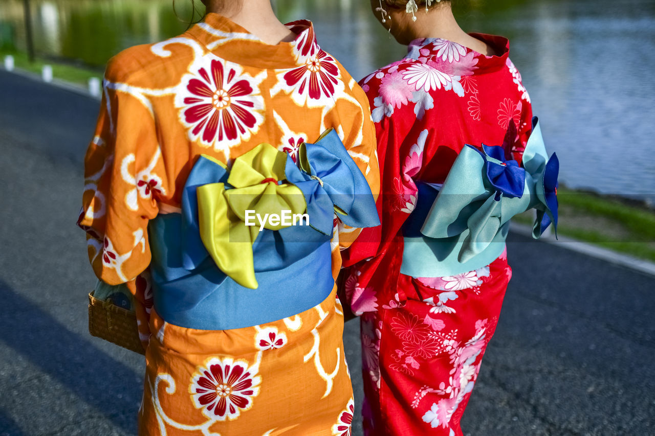 midsection of woman standing in traditional clothing