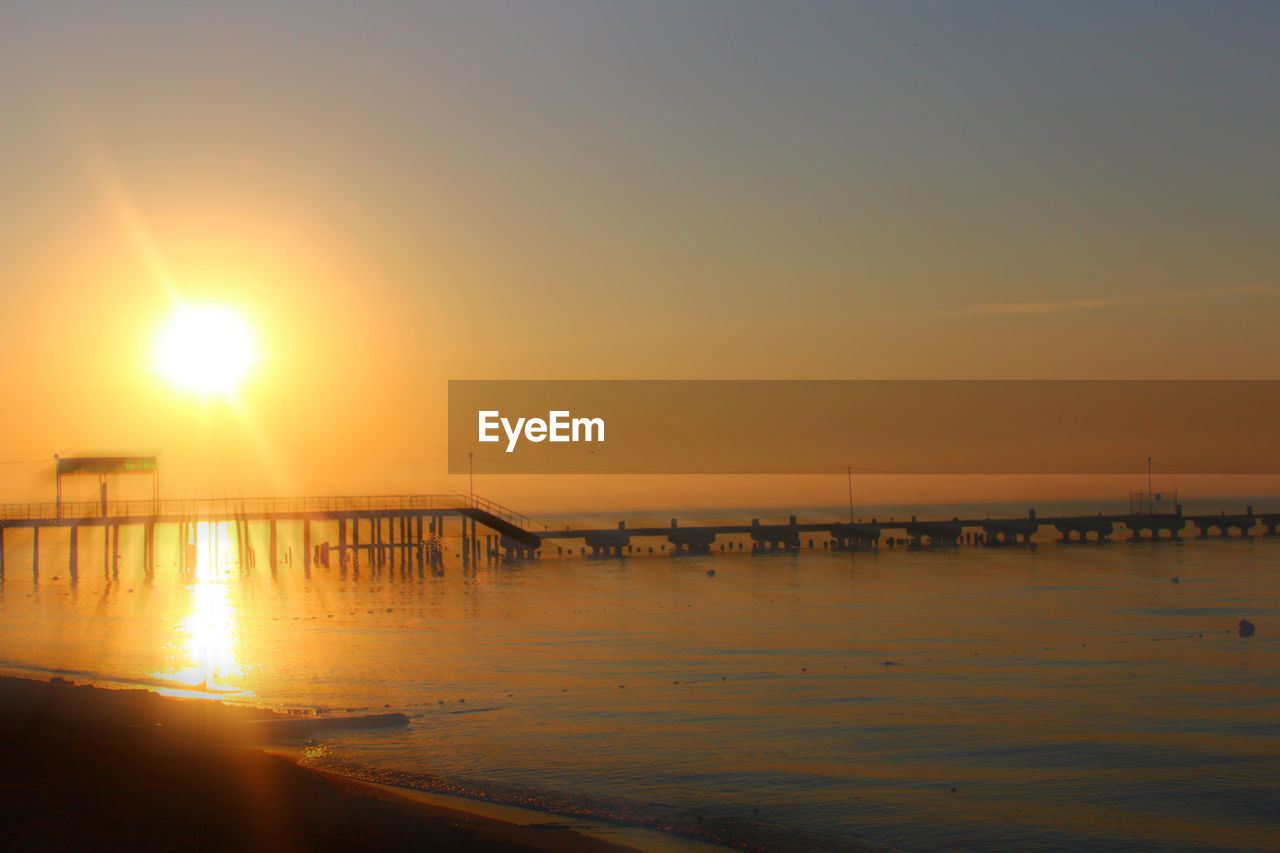 Pier over sea during sunset