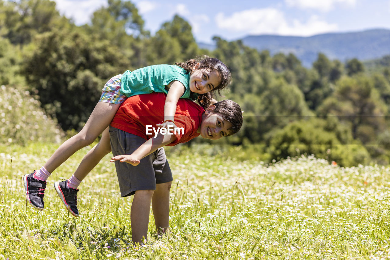 Rear view of two boys on field