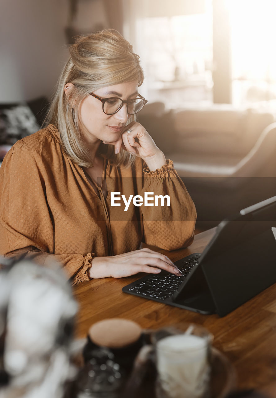 Businesswoman using laptop at home