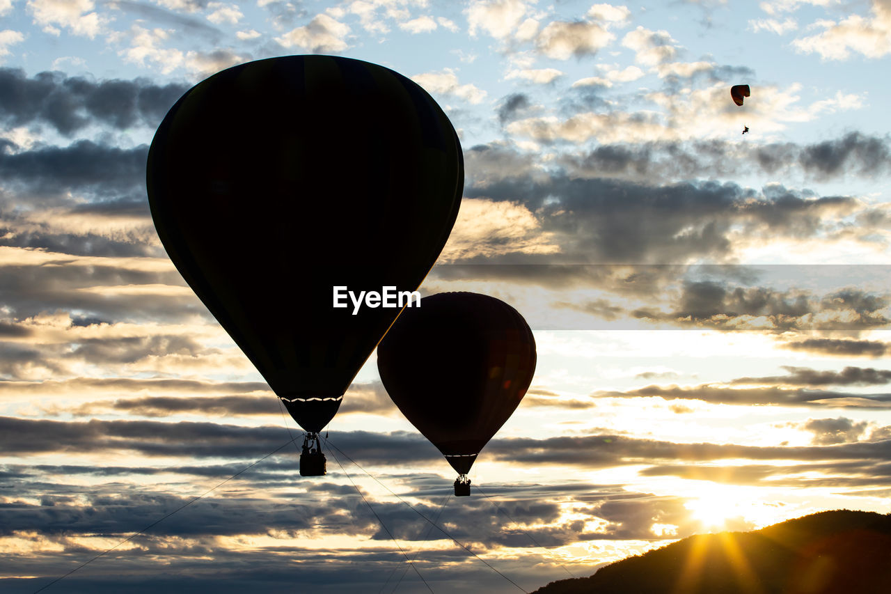 HOT AIR BALLOON FLYING AGAINST ORANGE SKY