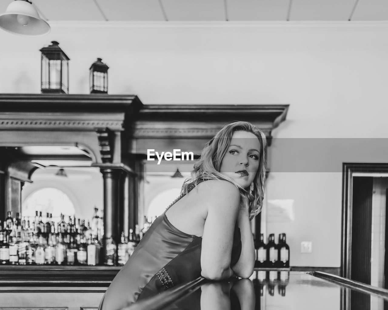 Woman looking away sitting at bar