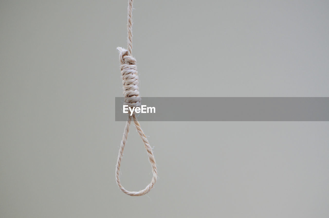 Hanging noose rope against white background