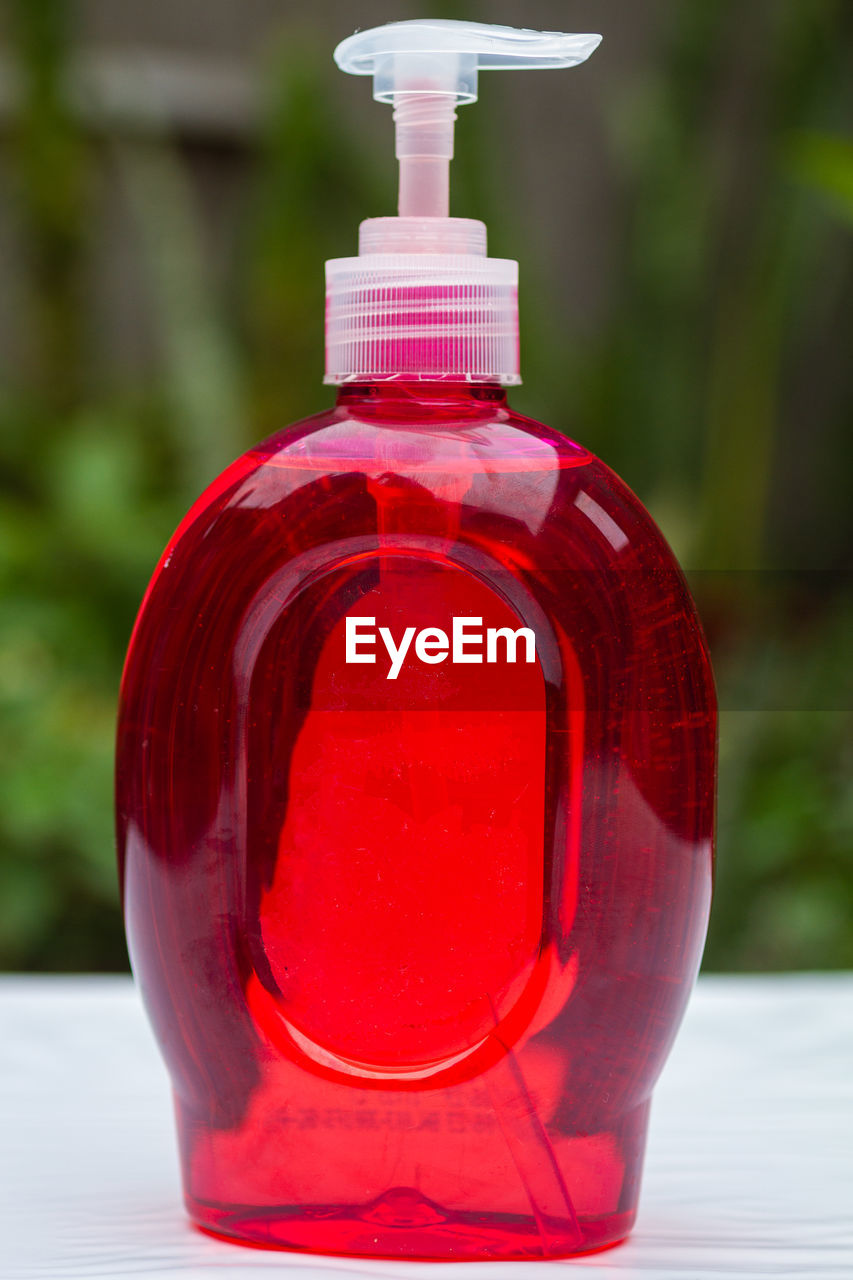 Close-up of soap bottle on  table