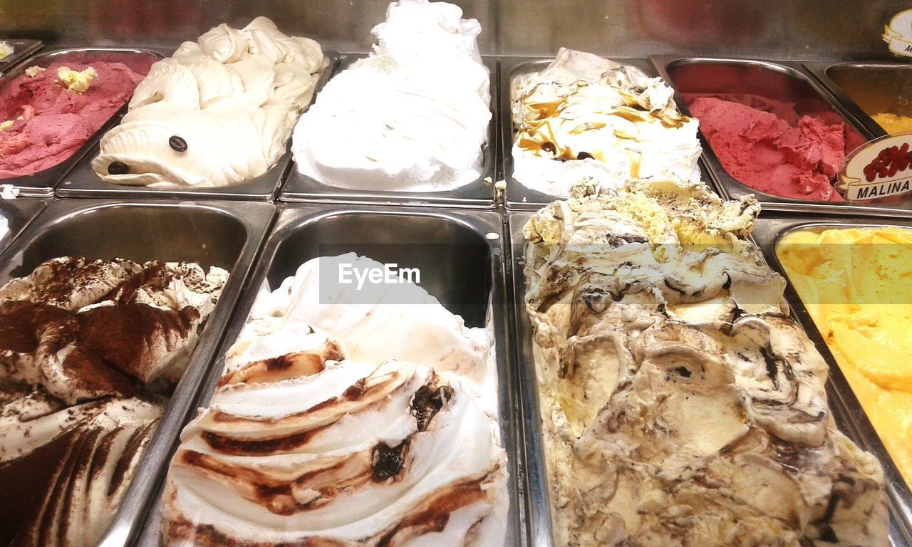Close-up of multi colored ice creams in display cabinet