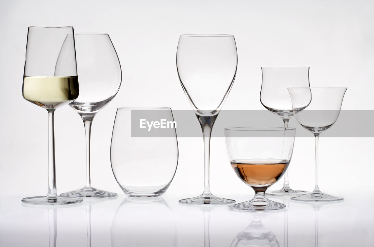 Close-up of drink glasses on white background