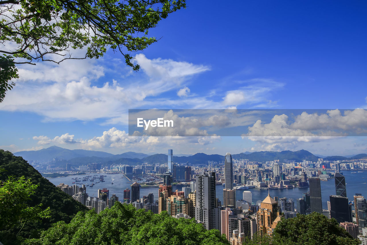 Modern buildings in city against cloudy sky