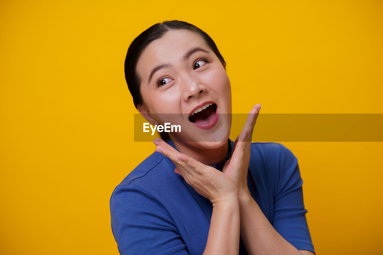 PORTRAIT OF MAN AGAINST YELLOW BACKGROUND