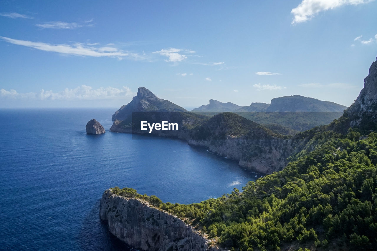 Scenic view of sea and mountains against sky