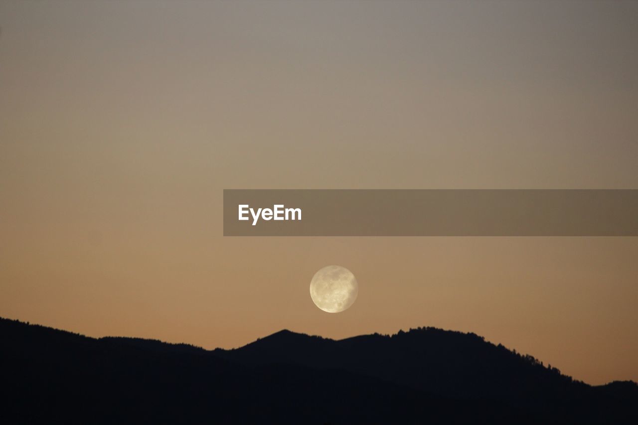 SILHOUETTE MOON AGAINST CLEAR SKY DURING SUNSET