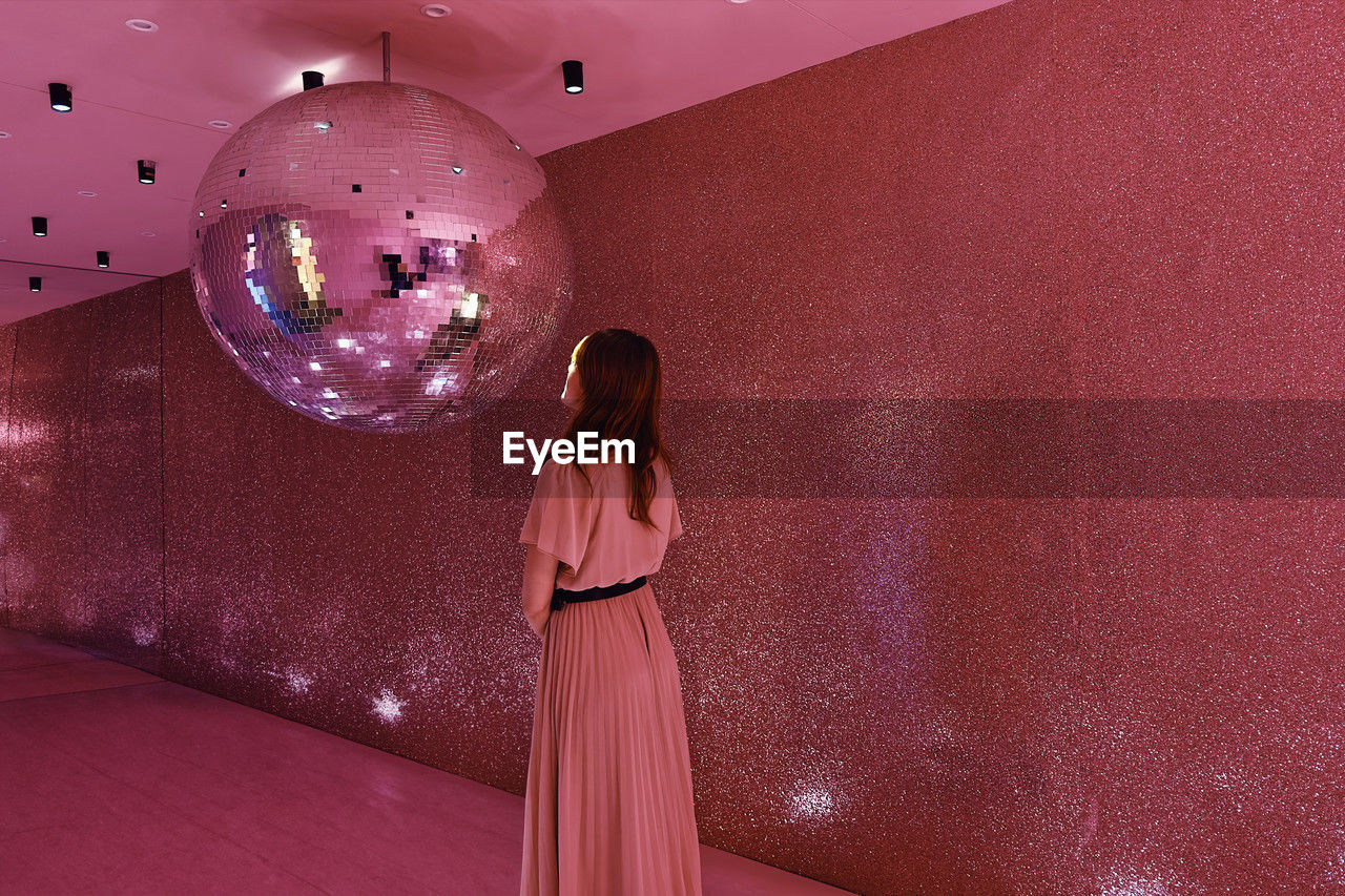 Woman in a pink room with a giant strobe