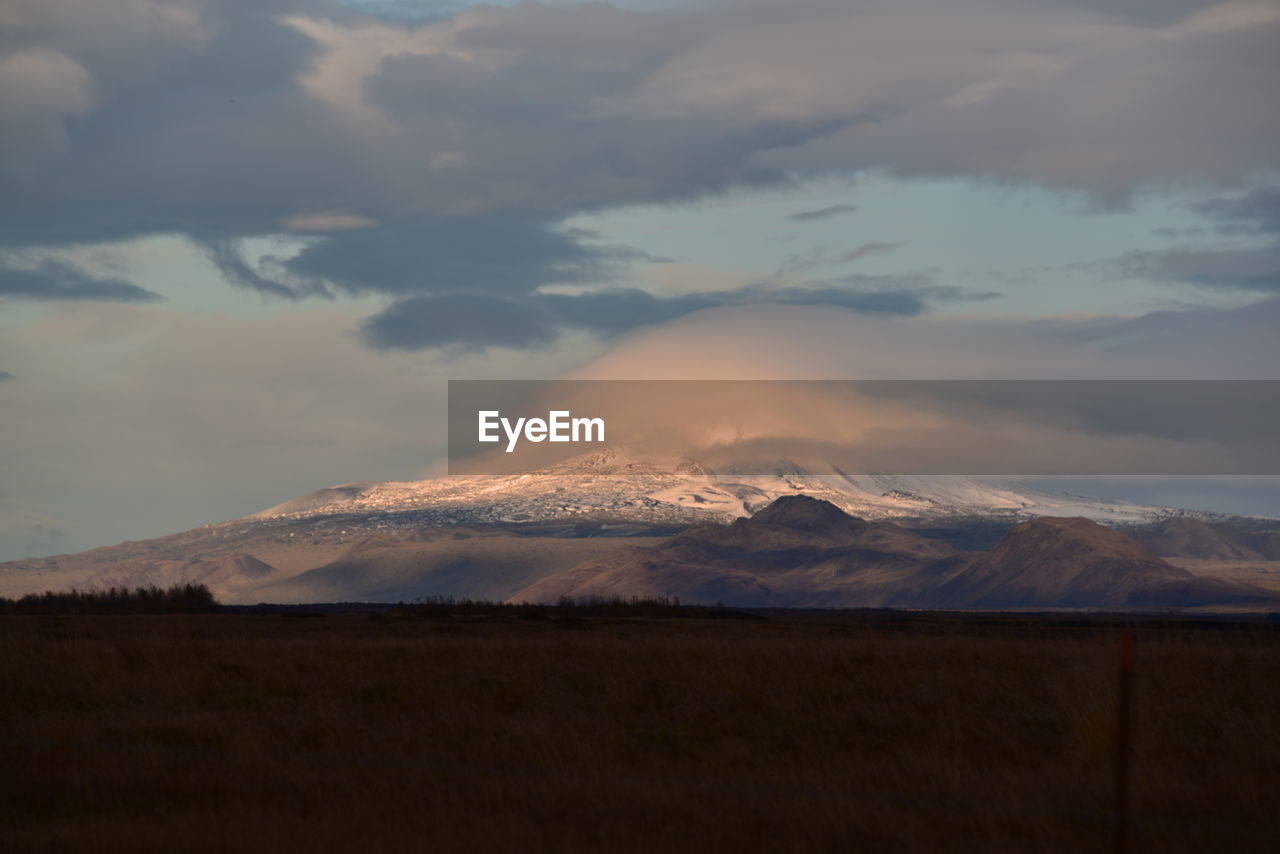 Scenic view of snowcapped mountains against sky during sunset