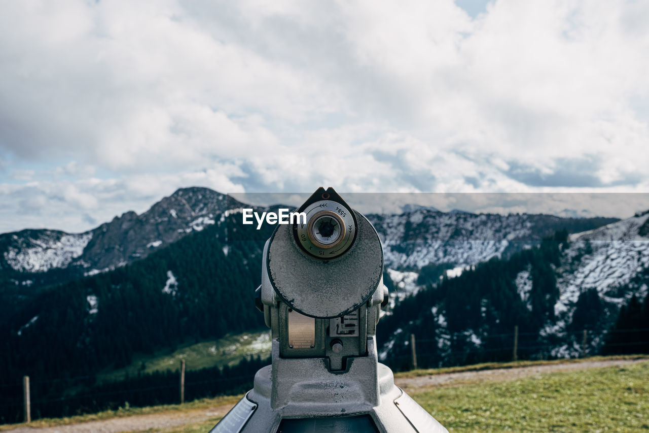 Binoculars against mountains during day