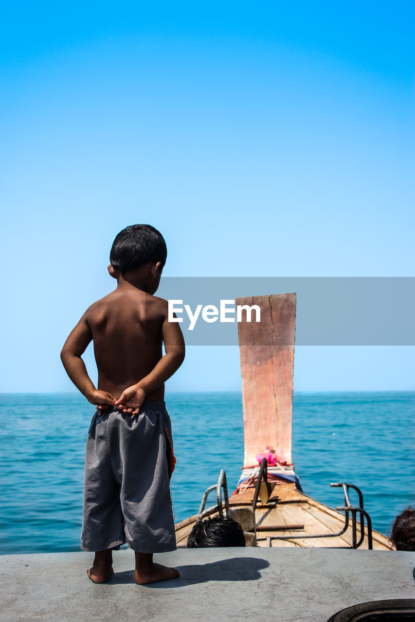 The sea boy stood on the roof of the boat.