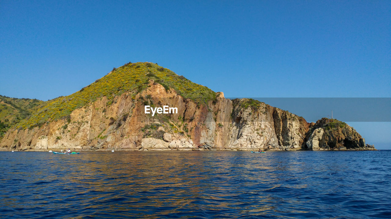 Scenic view of sea against clear blue sky