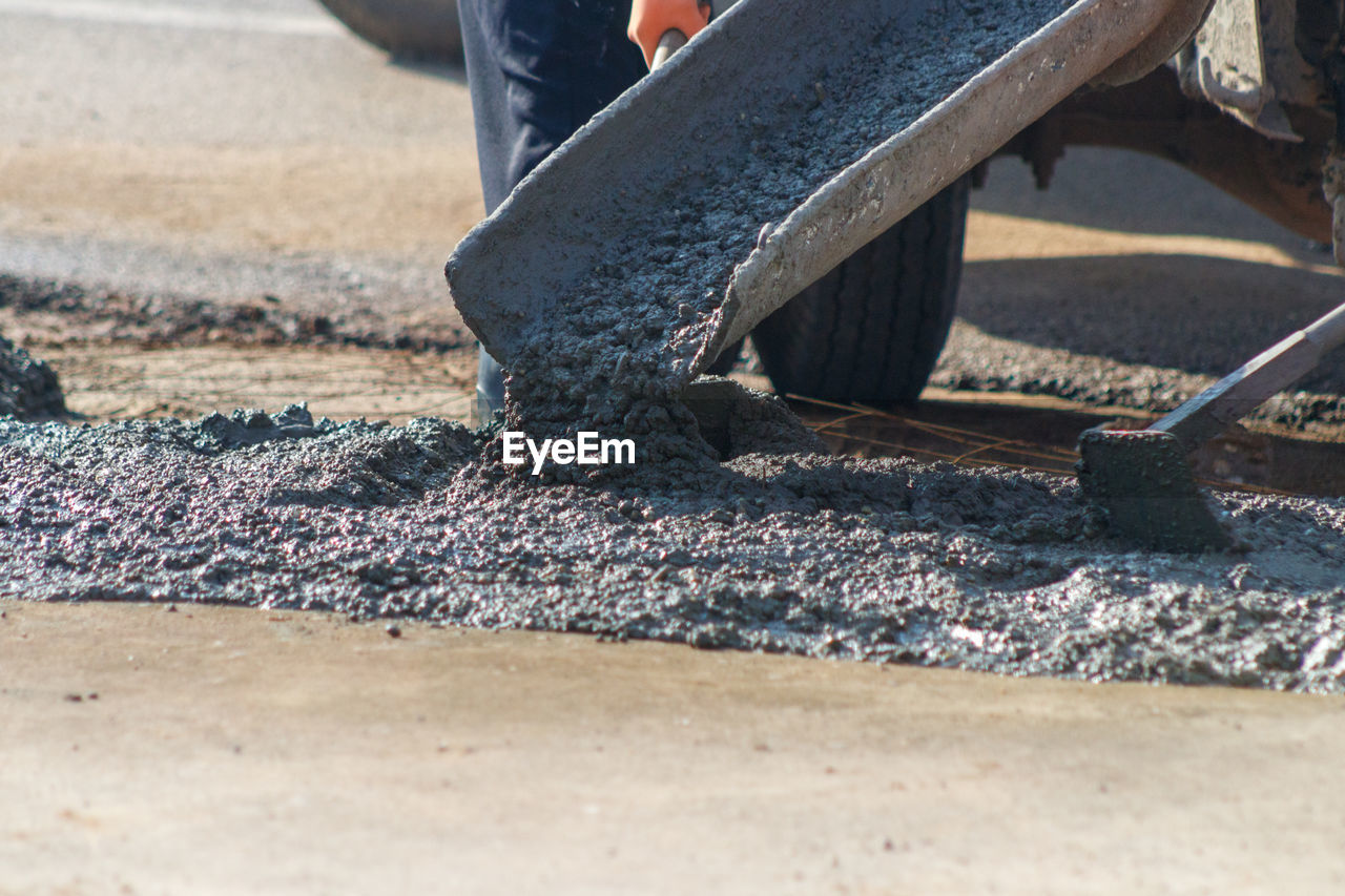 LOW SECTION OF MAN WORKING ON ROAD