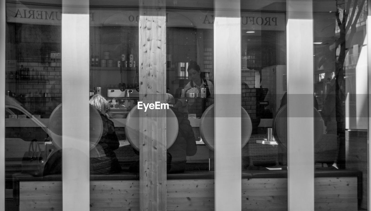 REFLECTION OF WOMAN ON MIRROR IN OFFICE