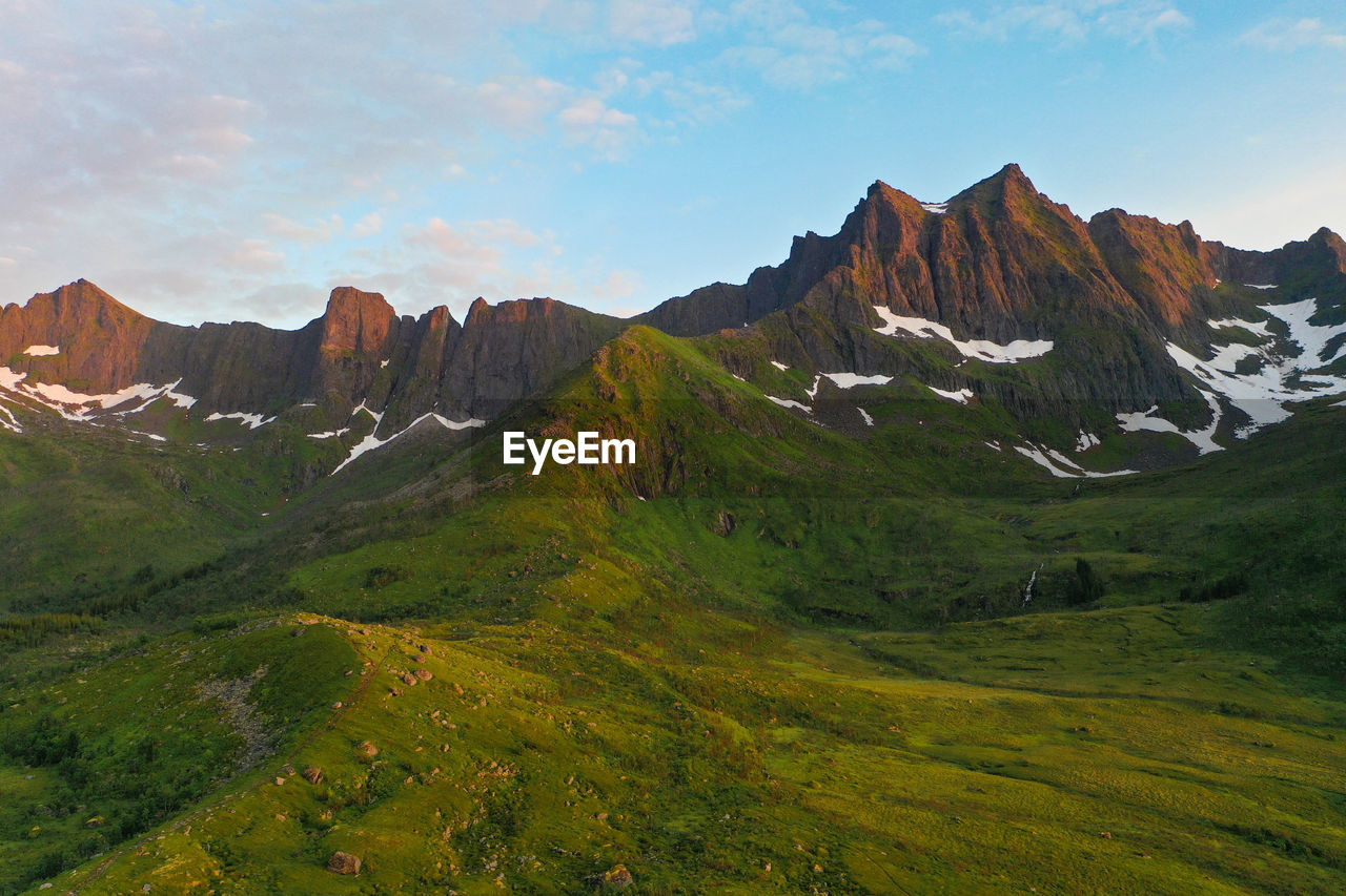 Mountain peaks with snow during sunset in senja island, norway