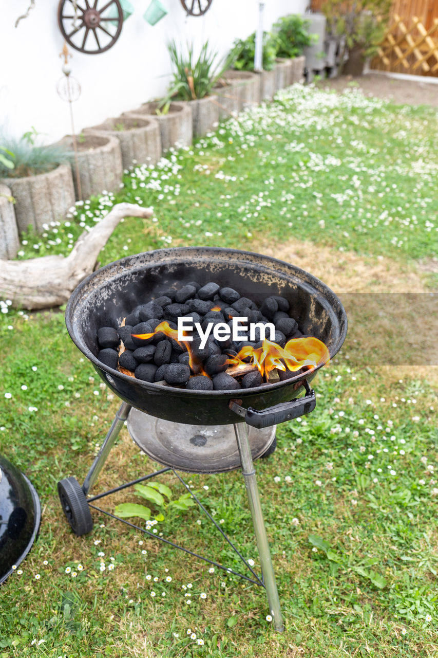 High angle view of meat on barbecue grill in yard