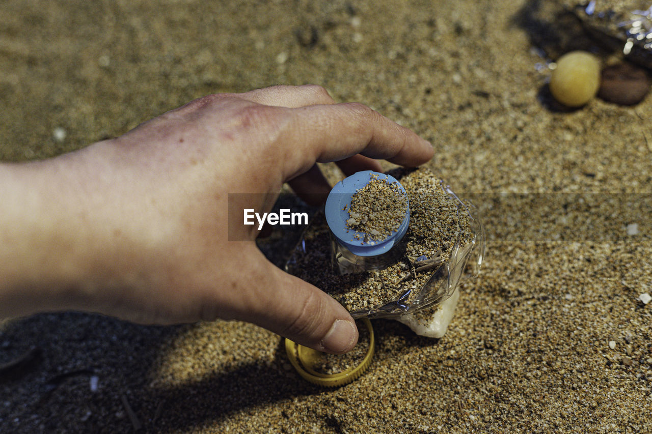 cropped hand of person holding coin