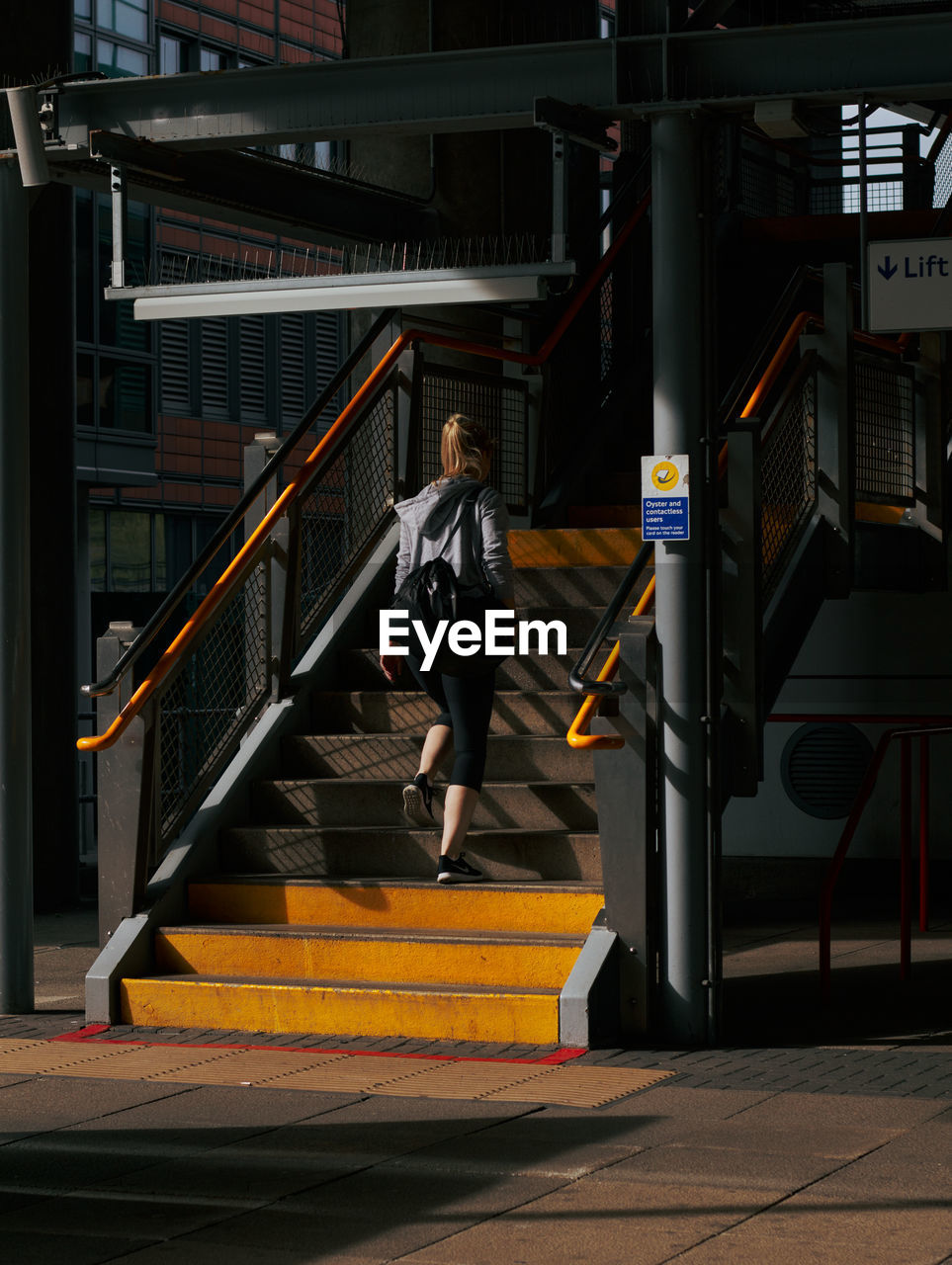 staircase, full length, architecture, one person, steps and staircases, adult, railing, stairs, person, motion, lifestyles, built structure, men, transportation, sports, sport venue, screenshot, young adult, city, clothing