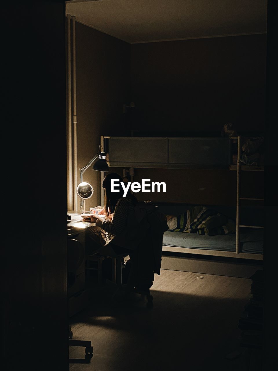 Rear view of man sitting in room