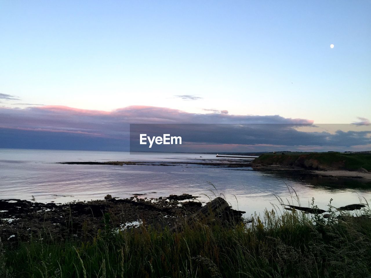 SCENIC VIEW OF RIVER AGAINST SKY DURING SUNSET