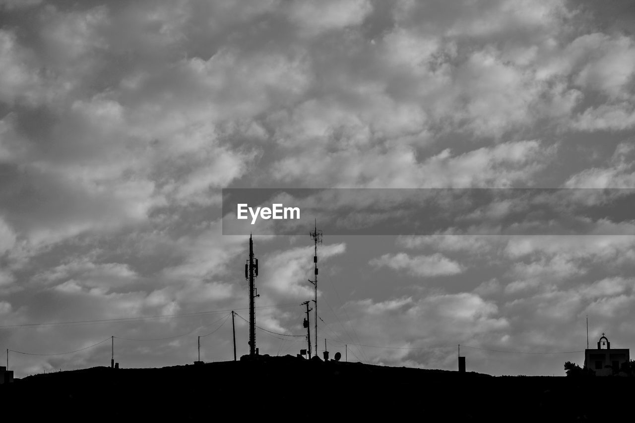 LOW ANGLE VIEW OF COMMUNICATIONS TOWER AGAINST SKY