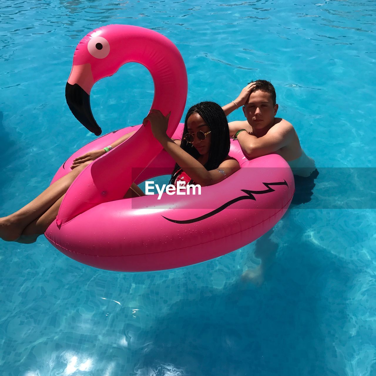 HIGH ANGLE VIEW OF SIBLINGS IN POOL