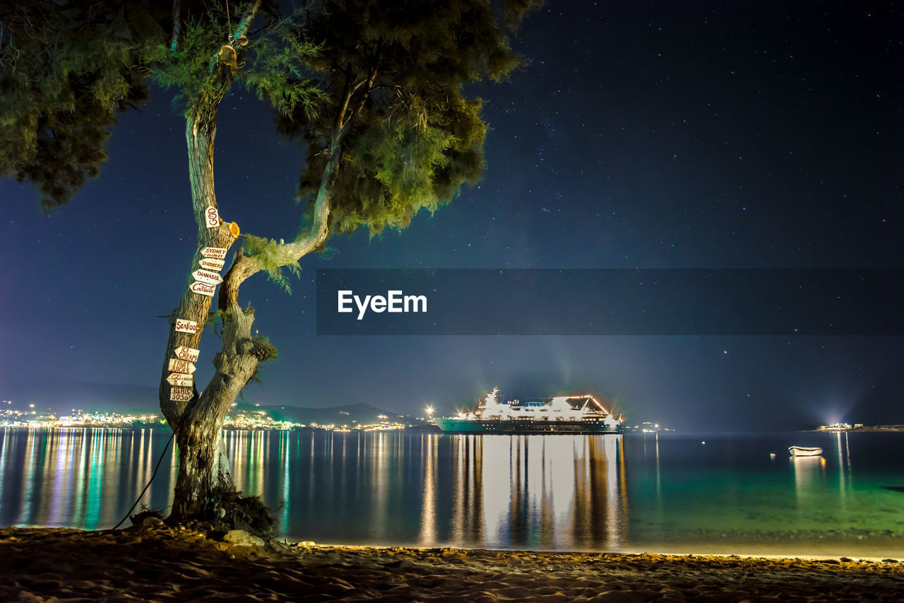 Side view of an illuminated ship in river