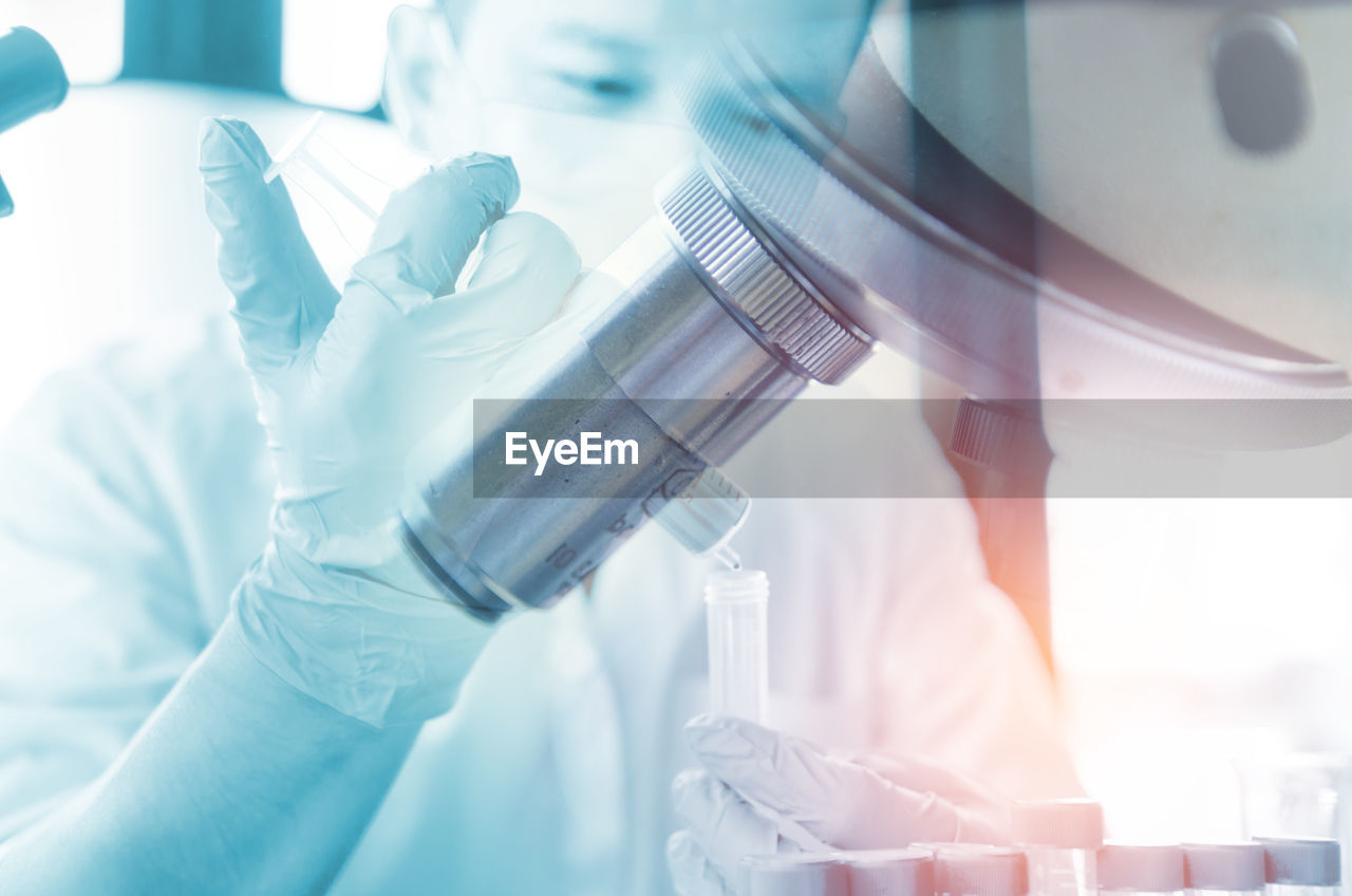 Close-up of male scientist analyzing chemical in laboratory