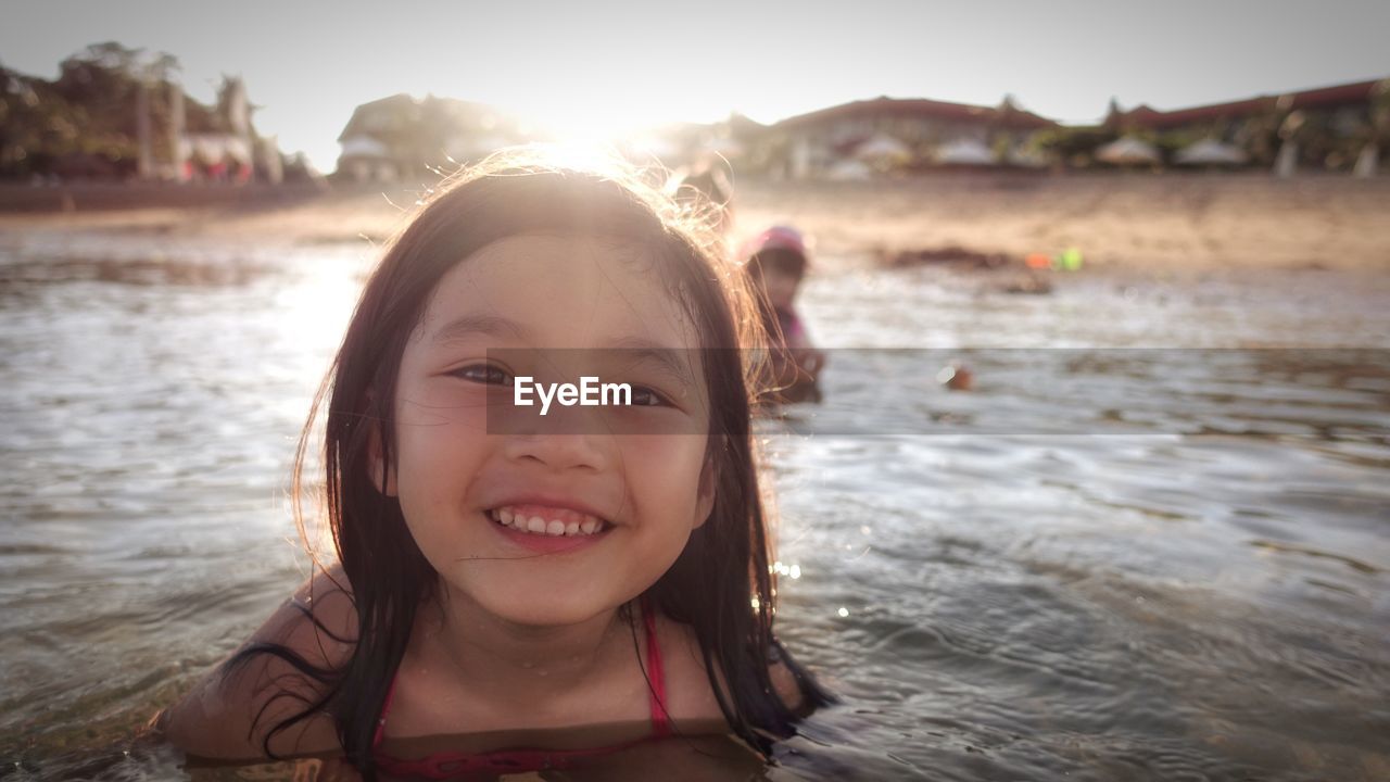 Portrait of smiling girl swimming in sea