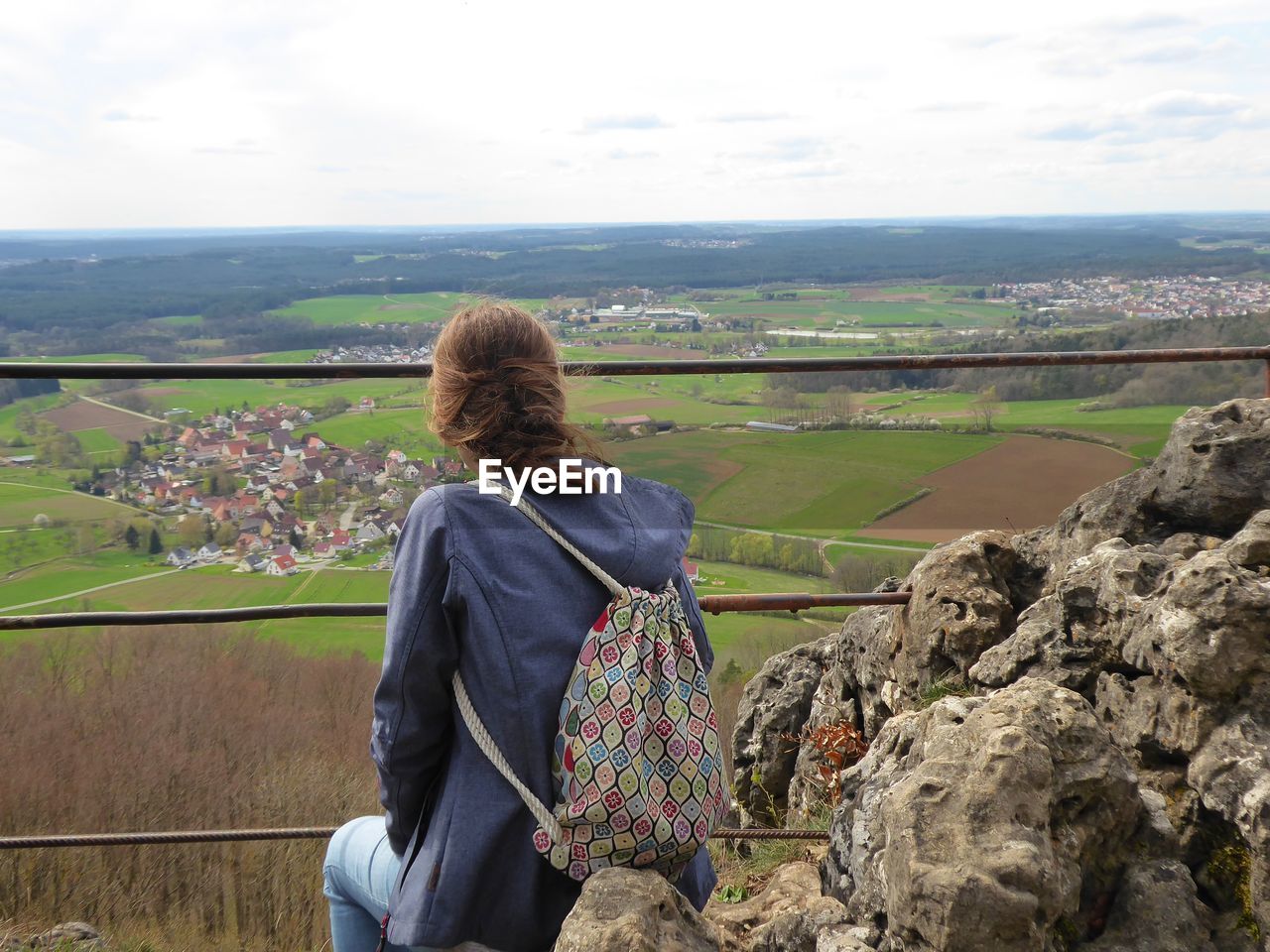 Woman looking at landscape against sky