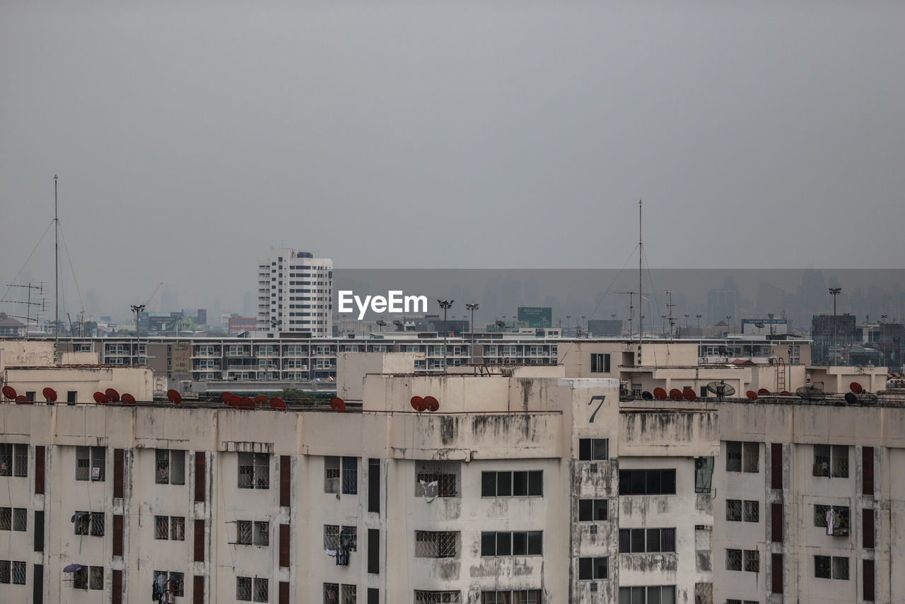 Buildings in city against clear sky