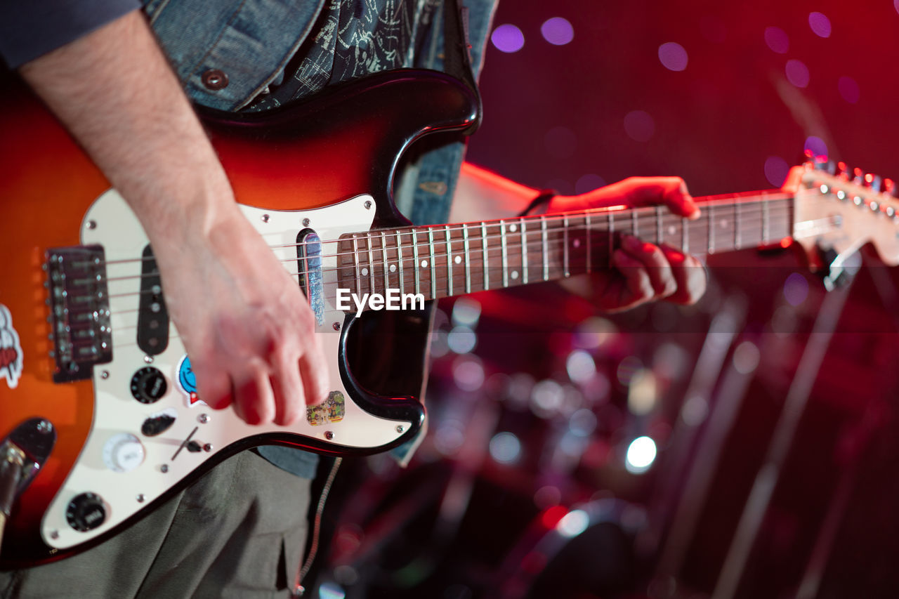 Close up play electric guitar at a rock concert