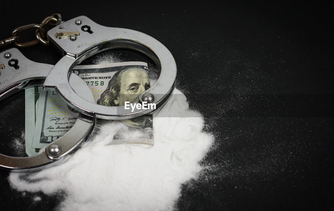 Close up of handcuffs and drugs