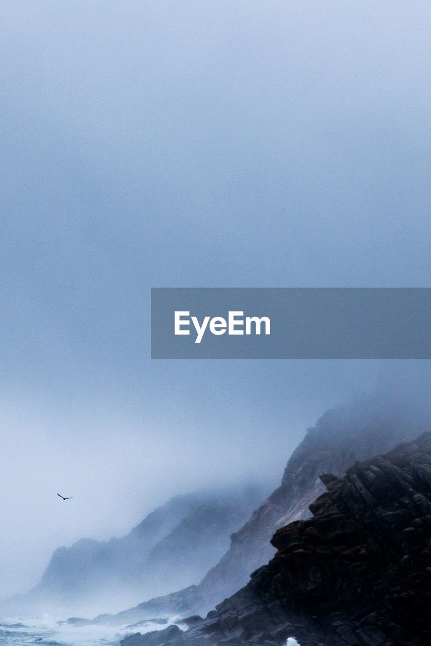 Scenic view of snow covered mountains against clear sky