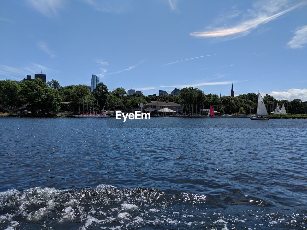 SCENIC VIEW OF RIVER BY TREES AND BUILDING AGAINST SKY