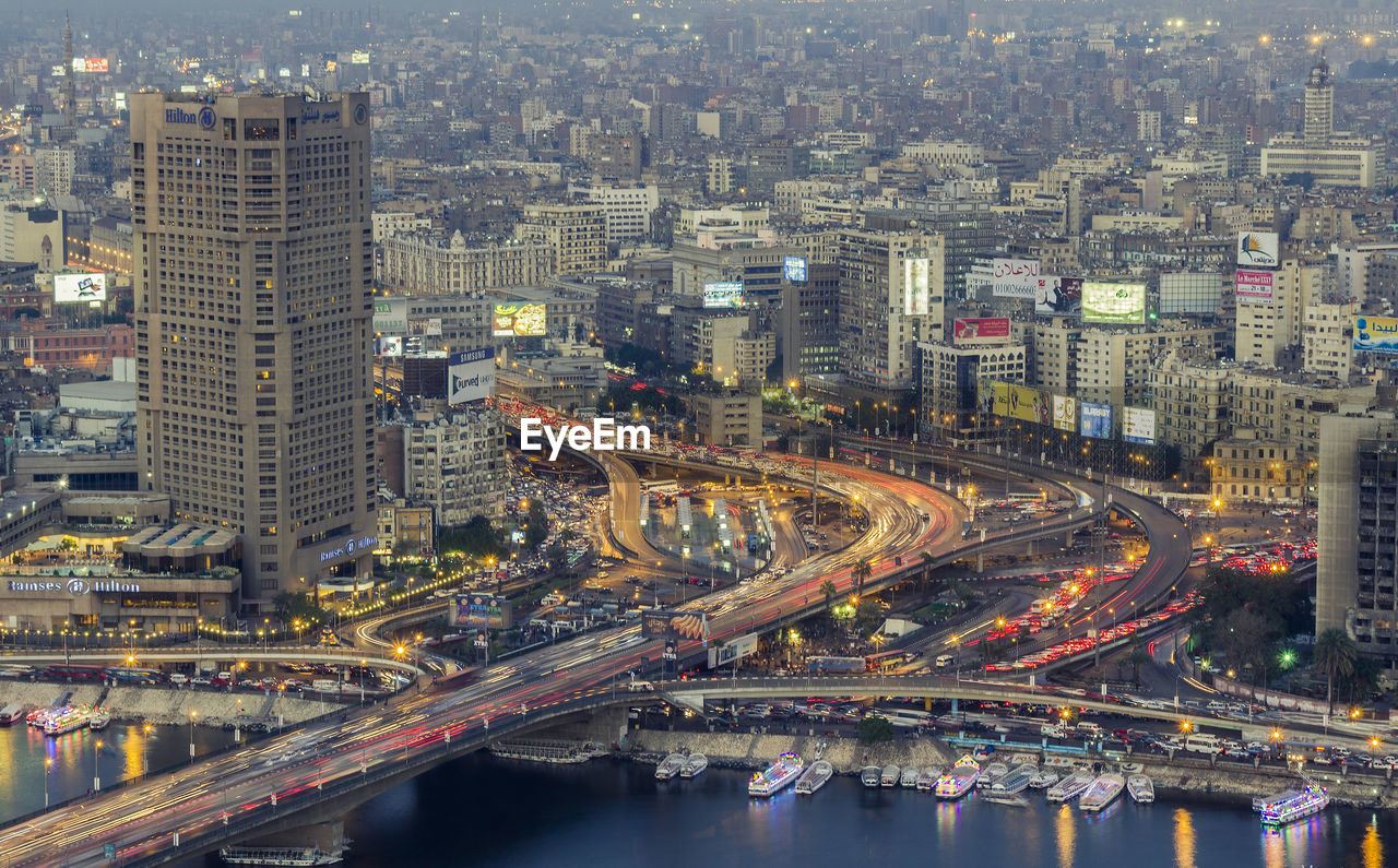 Aerial view of illuminated city street and buildings