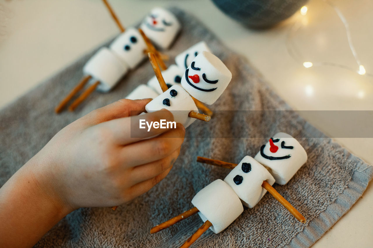 HIGH ANGLE VIEW OF BABY PLAYING WITH TOY