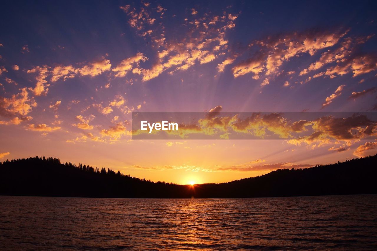 Scenic view of silhouette trees against sky during sunset