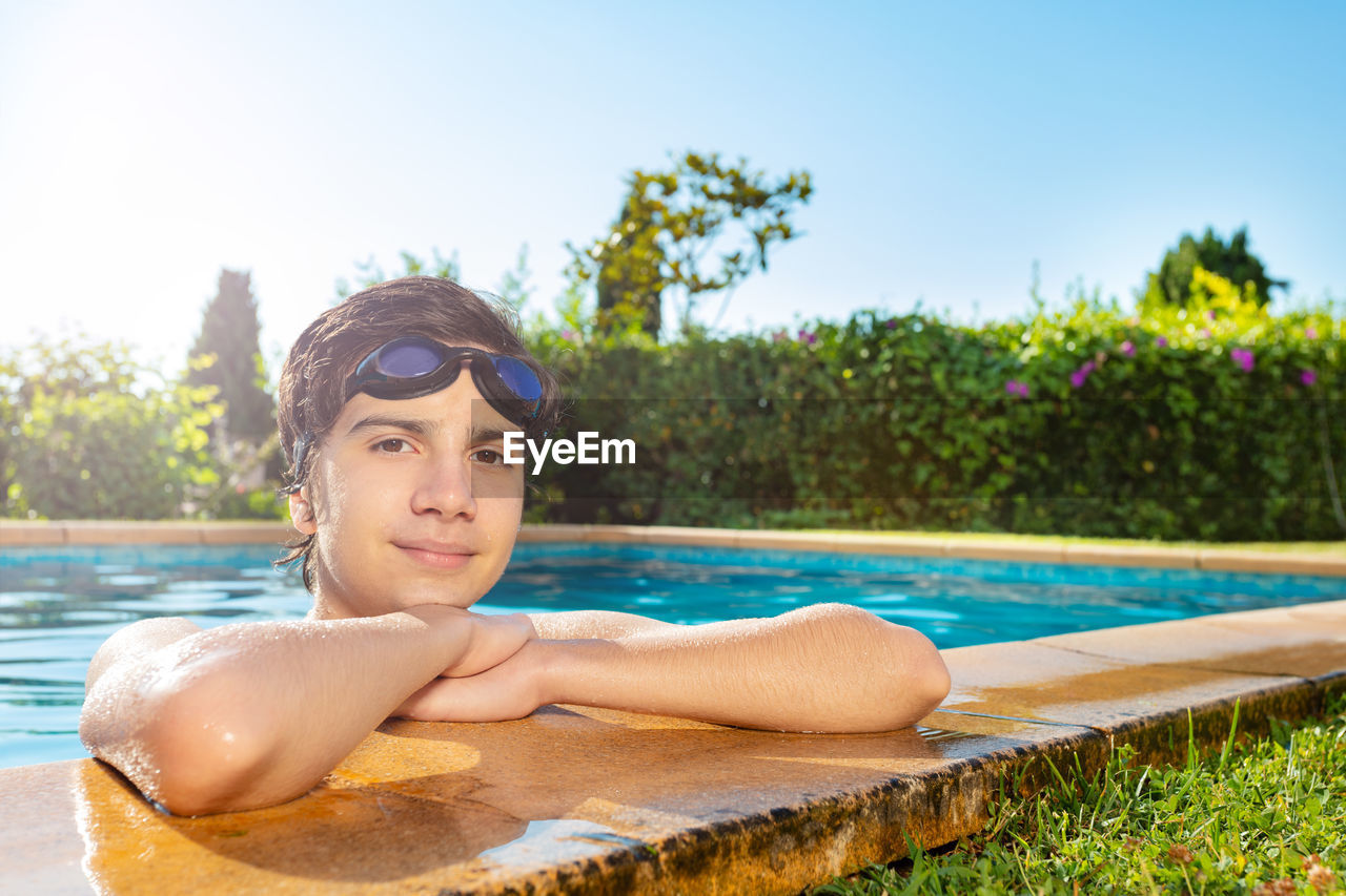 portrait of young man swimming in pool