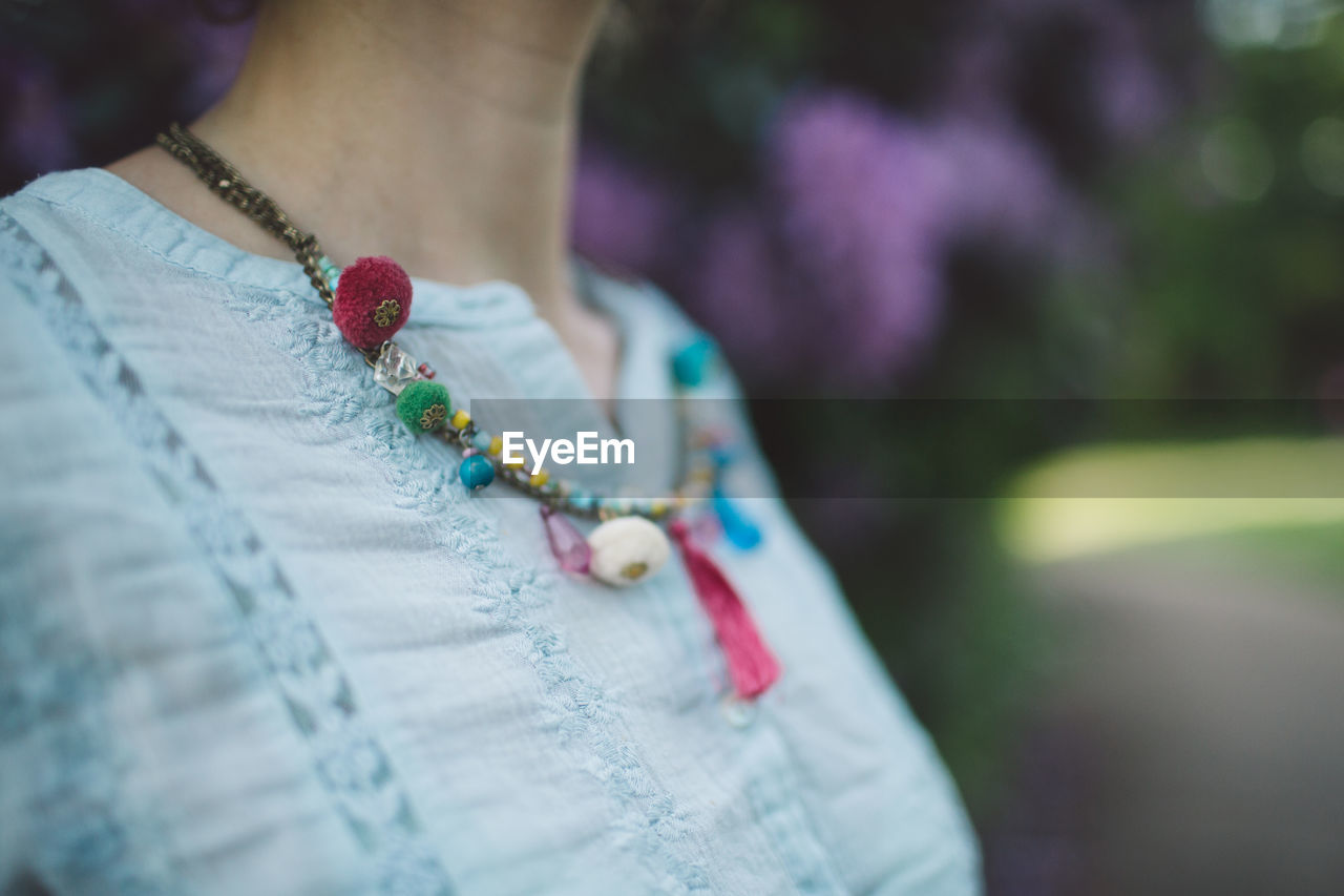 Close-up midsection of woman wearing necklace