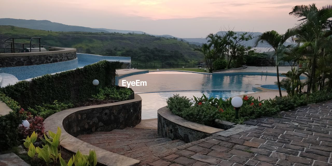 SWIMMING POOL BY LAKE AGAINST SKY