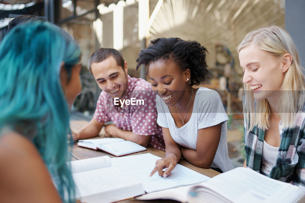 Cheerful friends studying at campus