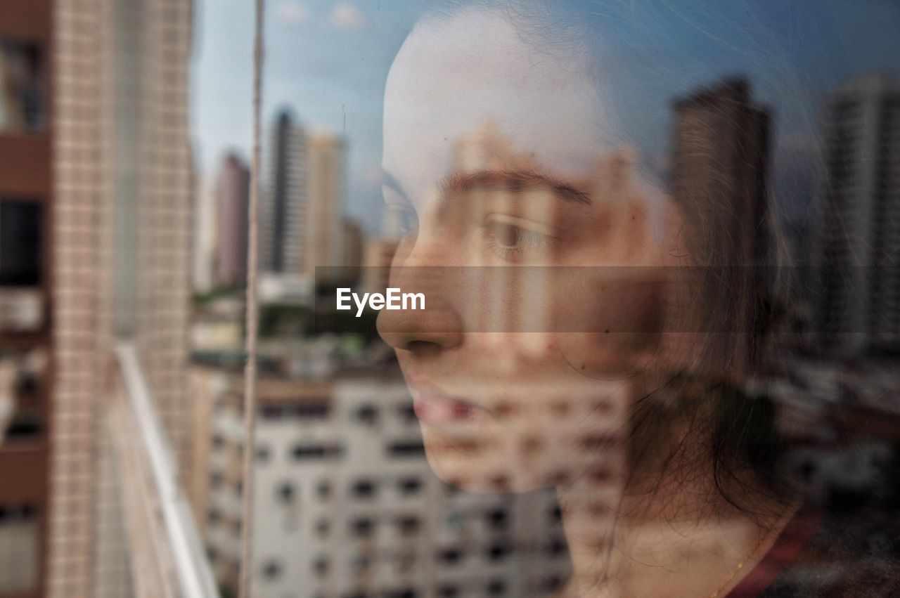 Beautiful girl looking at city buildings