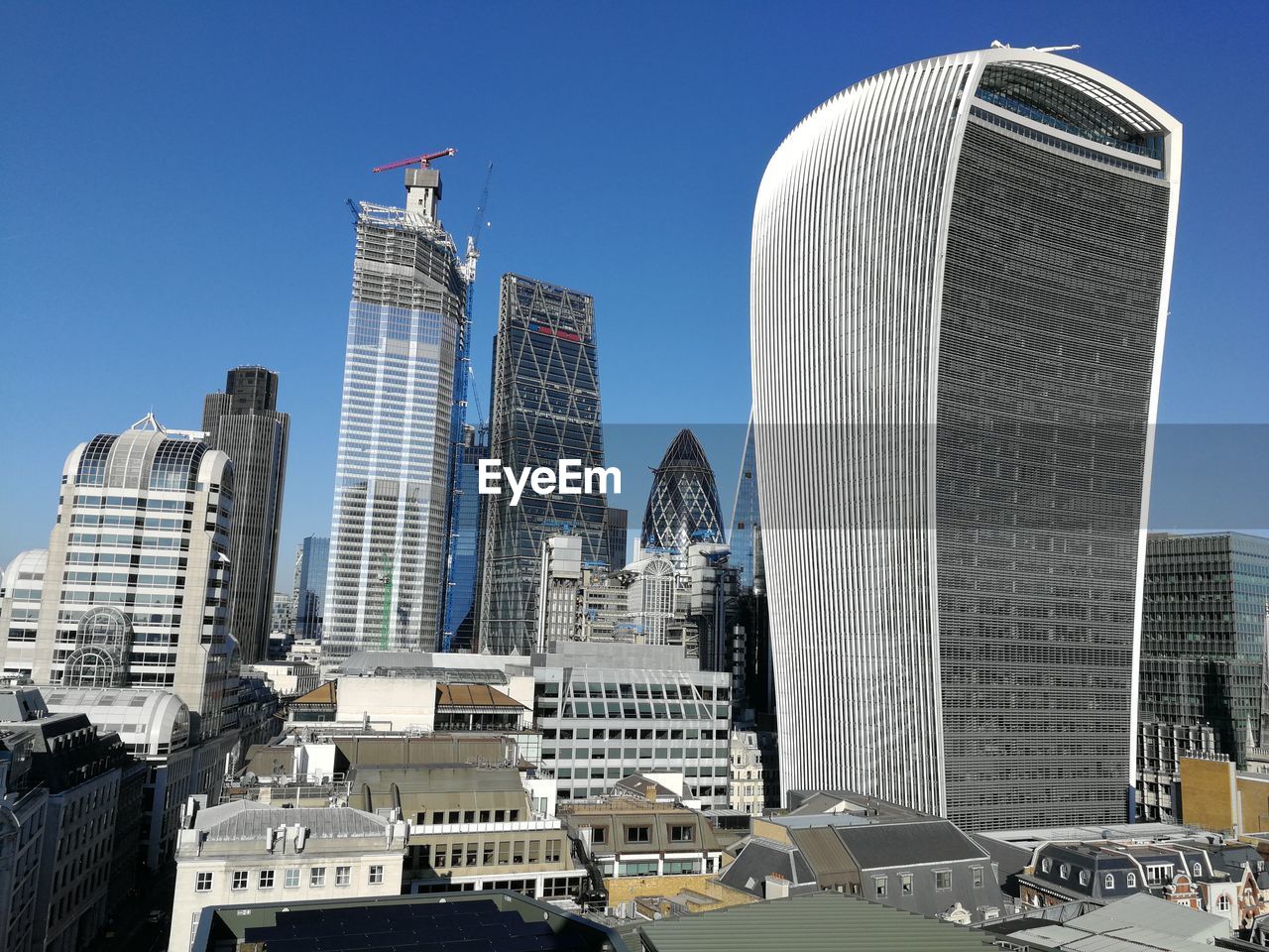 MODERN BUILDINGS IN CITY AGAINST CLEAR BLUE SKY