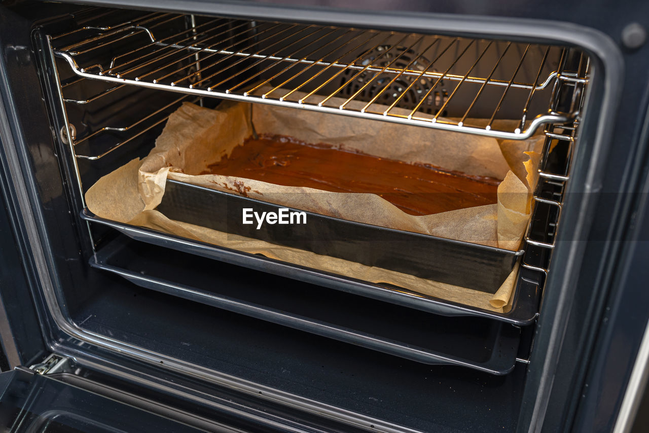 Baking tray with raw dough in the oven ready for baking.